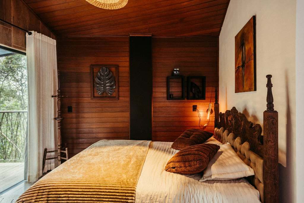 Reclaimed wood accent wall behind a bed used as a headboard