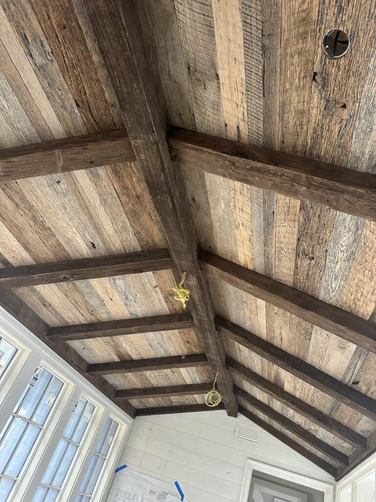 Chocolate brown hemlock reclaimed box beams on a vaulted plank ceiling at Lake Burton, Georgia