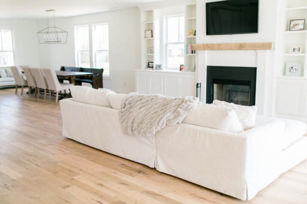 Living room with Kentucky paddock oak reclaimed flooring and white sofa